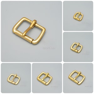 May include: Set of six gold-tone metal belt buckles in various sizes. Each buckle has a rectangular shape with a smooth, polished finish. The buckles are designed for belts with different widths, ranging from 19mm to 38mm.