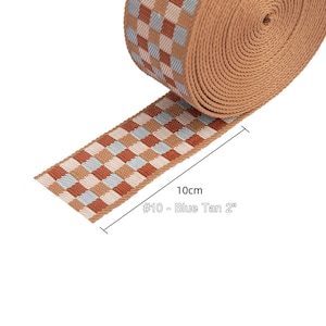 May include: A 10cm (4 inch) wide tan and blue checkered webbing strap. The strap is labeled "#10 - Blue Tan 2"