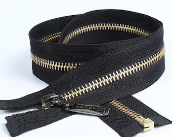 May include: A coiled black zipper with gold-colored teeth and a silver pull tab. The pull tab is rectangular and has the word "SPORT" printed on it. The zipper is made of a durable material and is suitable for various sewing projects.