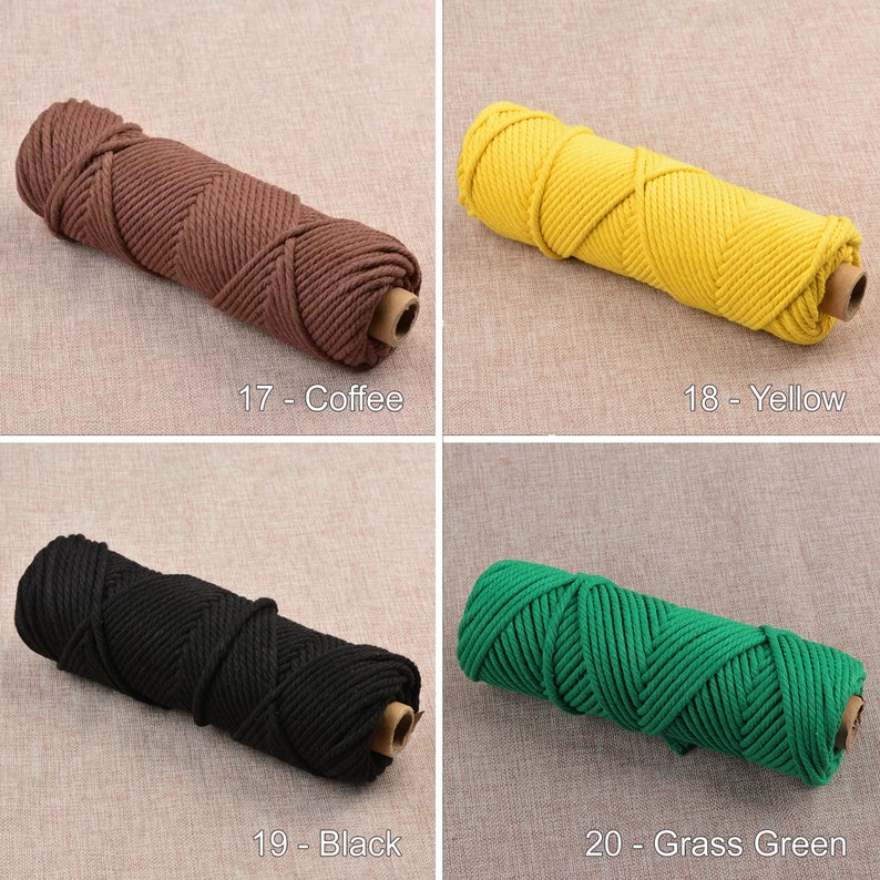 May include: Four spools of cotton rope in different colors: coffee, yellow, black, and grass green. The rope is thick and has a braided texture.