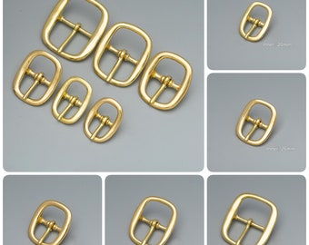 May include: Assortment of gold-toned metal belt buckles in various sizes. The buckles are rectangular with a smooth finish and a centre bar. The sizes are labelled "Inner: 20mm", "Inner: 26mm", "Inner: 30mm", "Inner: 35mm", and "Inner: 38mm".