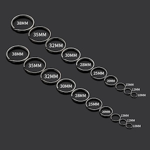 May include: A set of 11 silver key rings in various sizes, ranging from 10mm to 38mm in diameter. The key rings are arranged in a staggered pattern, with the largest rings at the top and the smallest rings at the bottom.