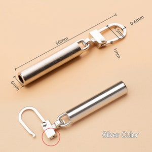May include: Silver-toned metal connector with a 5 cm long tube and a 0.8 cm loop. The connector has a 1 cm long hook and a 0.6 cm wide opening. Silver Color.