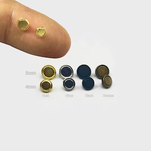 May include: Assortment of 5mm and 4mm round metal buttons in gold, silver, black, and bronze colors.