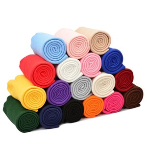 May include: A collection of 18 rolled up knit fabric strips in various colors, including red, blue, green, yellow, orange, purple, brown, pink, and white.