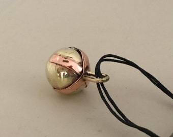 Brass Ball Pendant with a Copper X across the top on a Black Leather cord.