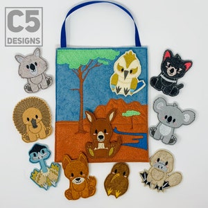 May include: A felt play set with a blue background and a variety of Australian animals, including a kangaroo, a kookaburra, a wombat, and a koala. The set is designed for children to learn about Australian wildlife.