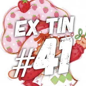 May include: A pink and white illustration of a strawberry character with a red hat and a white dress. The text "Ex Tin #41" is superimposed on the image.