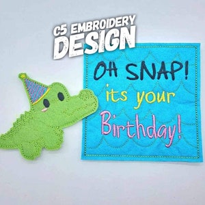 May include: An embroidered applique featuring a green alligator wearing a party hat and a blue square with the text "OH SNAP! its your Birthday!" in black, yellow, and pink.