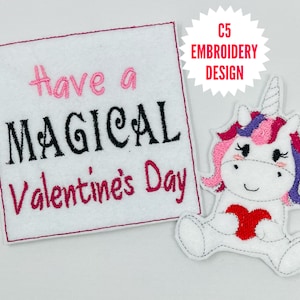 May include: Embroidered design featuring a pink and purple unicorn holding a red heart with the text "Have a Magical Valentine's Day".