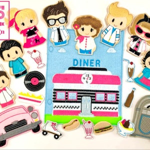 May include: A set of felt finger puppets featuring a 1950s diner theme. The set includes a pink car, a diner building, a jukebox, a milkshake, a hot dog, a hamburger, a record, a roller skate, and several characters dressed in 1950s clothing. The text "DINER" is printed on the diner building.