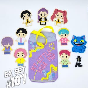 May include: A felt set featuring a purple soda can-shaped bag with the text "MY LITTLE SODA POP" and several felt character figures. The set includes a blue cat, and the text "EX SET #107".