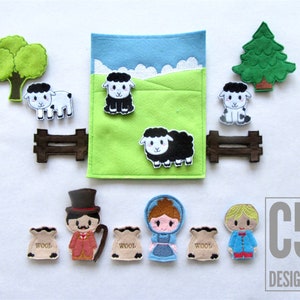 May include: Felt play set featuring a green field, blue sky, white clouds, a brown fence, a green tree, and a black sheep. There are also four finger puppets: a shepherd with a red waistcoat, a girl with a blue dress, a boy with a blue shirt, and a bag of wool.