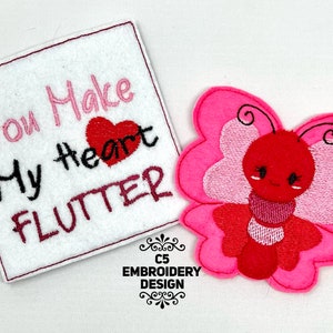 May include: Embroidered patches featuring a pink butterfly and a white square with the text "You Make My Heart Flutter". The butterfly has a red body and pink wings. The square has a red border.