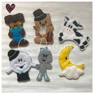 May include: Set of six felt finger puppets featuring a brown dog wearing overalls, a brown bear wearing a top hat and bow tie holding a violin, a black and white cow, a gray character wearing a bow, a white character wearing a top hat and bow tie, and a yellow crescent moon on a white cloud.