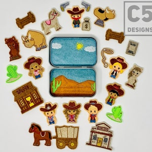 May include: A set of felt western-themed play pieces in a tin box. The pieces include cowboys, a horse, a cow, a wagon, a saloon, a cactus, a sheriff's office, and a lasso. The tin box has a blue lid with clouds and a sun.