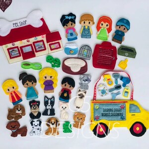 May include: Felt finger puppets of people and animals, a red felt pet shop building, a yellow felt mobile grooming van with the text "Dashing Doggy Mobile Grooming", and various felt accessories such as a dog bed, a cage, a lead, and a bowl.