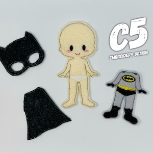 May include: A felt doll with a black mask, cape, and a gray and yellow Batman costume. The doll is labeled "C5 Embroidery Design".
