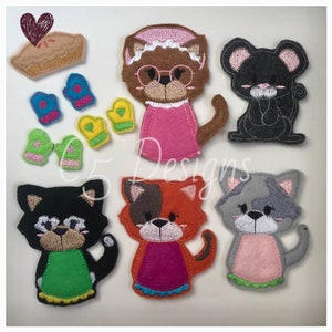 May include: A set of felt finger puppets featuring a brown cat wearing glasses and a pink dress, a black cat wearing a green dress, a red and white cat wearing a pink dress, a gray cat wearing a green dress, a black mouse, and a pie with a heart on top. There are also four pairs of felt mittens in blue, yellow, and green.