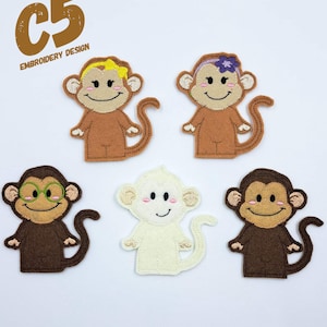 May include: Five felt monkey finger puppets. One monkey is brown with green glasses, one is brown with a yellow bow, one is brown with a purple flower, one is white, and one is brown.