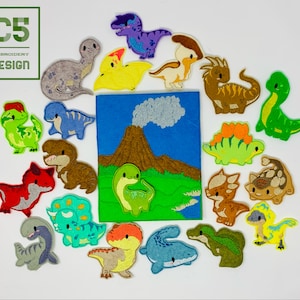 May include: A set of felt dinosaur appliques, including a volcano, a green dinosaur, a red dinosaur, a blue dinosaur, a brown dinosaur, a yellow dinosaur, a purple dinosaur, a grey dinosaur, a tan dinosaur, a white dinosaur, a light blue dinosaur, a dark blue dinosaur, a light green dinosaur, a dark green dinosaur, and an orange dinosaur.