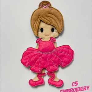 May include: Embroidered felt appliqué of a ballerina doll with brown hair, a pink dress, and pink shoes. The doll is wearing a pink bow in her hair. The text "C5 EMBROIDERY DESIGN" is visible in the bottom right corner of the image.