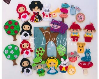 May include: A collection of felt finger puppets and decorative pieces featuring characters and items from Alice in Wonderland, including Alice, the Queen of Hearts, the Mad Hatter, the White Rabbit, the Cheshire Cat, trees, and an Eat Me cookie.
