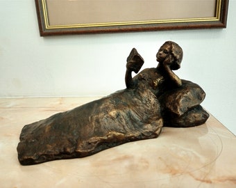 Realistic bronze sculpture, a bronze statuette of  young woman reading a book