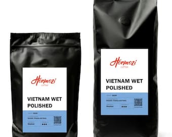 May include: Two black coffee bags with white labels. The labels read "Hormozi coffee" and "VIETNAM WET POLISHED". The bottom of the label has a blue section with text and a QR code. The coffee is described as smooth, creamy, and nutty.