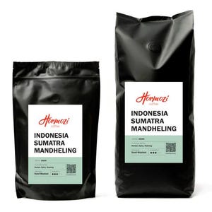 May include: Two black coffee bags with white labels. The labels read "Hormozi Coffee" and "Indonesia Sumatra Mandheling." The bags also list flavour notes and are labelled "Semi-Washed."