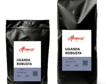 May include: Two black coffee bags with white labels. The labels read "Hormozi coffee" and "UGANDA ROBUSTA". The smaller bag is on the left, and the larger bag is on the right. The bags have a matte finish.