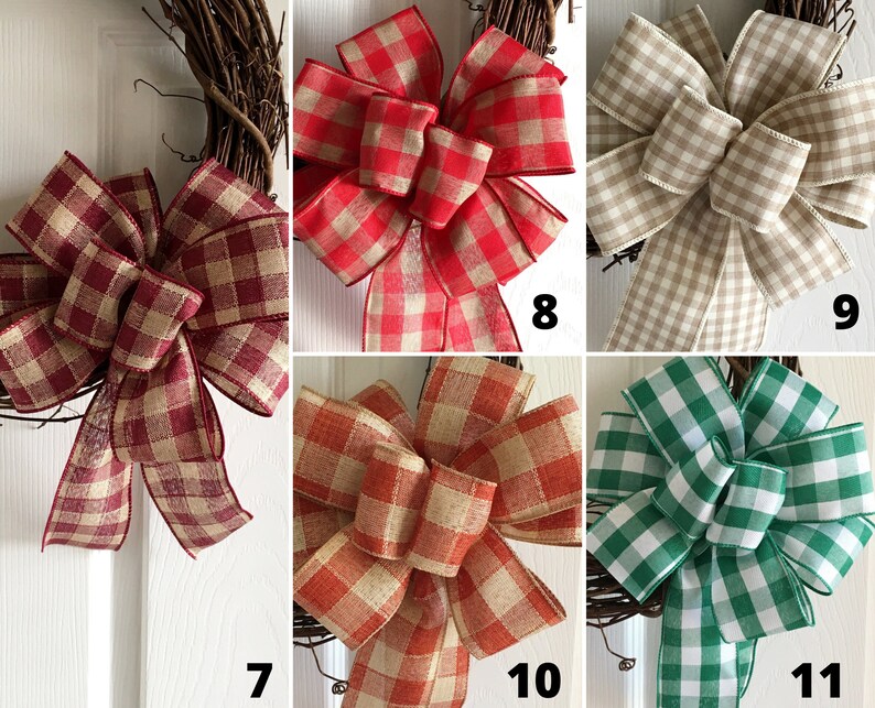 May include: A collection of six different plaid bows, each with a different color combination. The bows are made of a burlap-like material and are tied with a simple knot. The colors include red, tan, green, and burgundy.