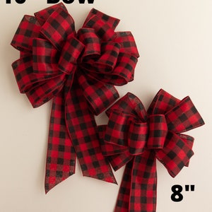 May include: Two red and black buffalo plaid bows. The larger bow is 10 inches and the smaller bow is 8 inches.