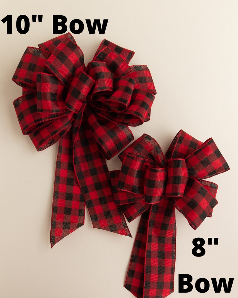May include: Two red and black buffalo plaid bows. The larger bow is 10 inches and the smaller bow is 8 inches.