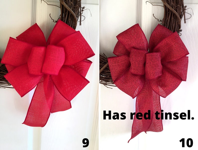 May include: Two red burlap bows on a grapevine wreath. The bow on the right has red tinsel.