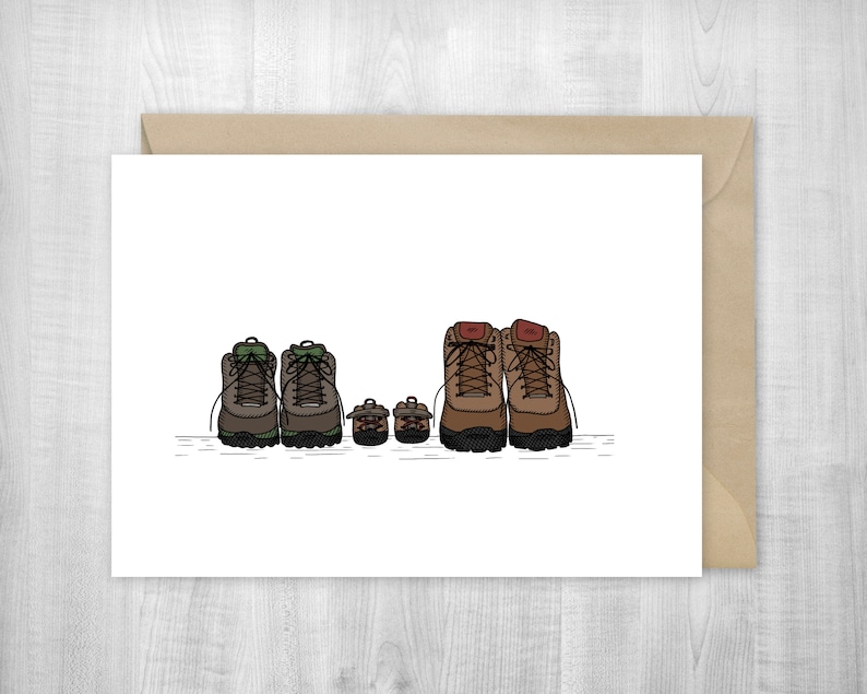 May include: A white card with a drawing of four pairs of hiking boots. The boots are brown, green, and black. The boots are lined up in a row, with the largest pair at the front and the smallest pair at the back.