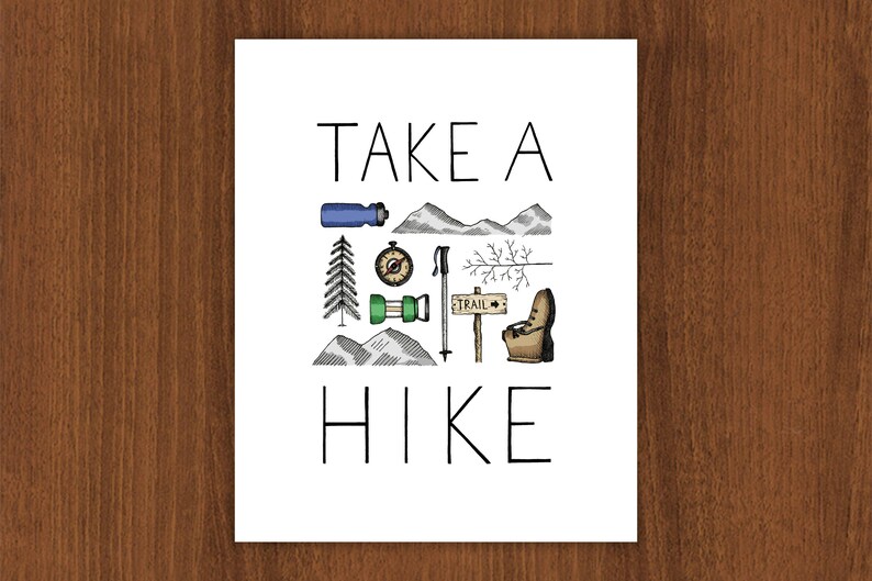 May include: A white print featuring the text "TAKE A HIKE" and illustrations of hiking equipment. The image includes a water bottle, compass, mountains, a pine tree, hiking poles, and a trail sign. The artwork is in black, green, blue, and brown.