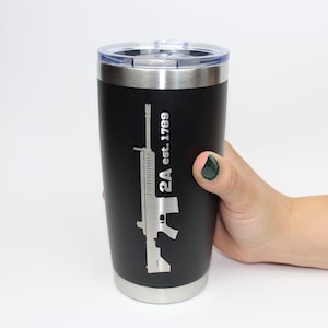 May include: Black stainless steel tumbler with a silver silhouette of a rifle and the text "2A est. 1789".