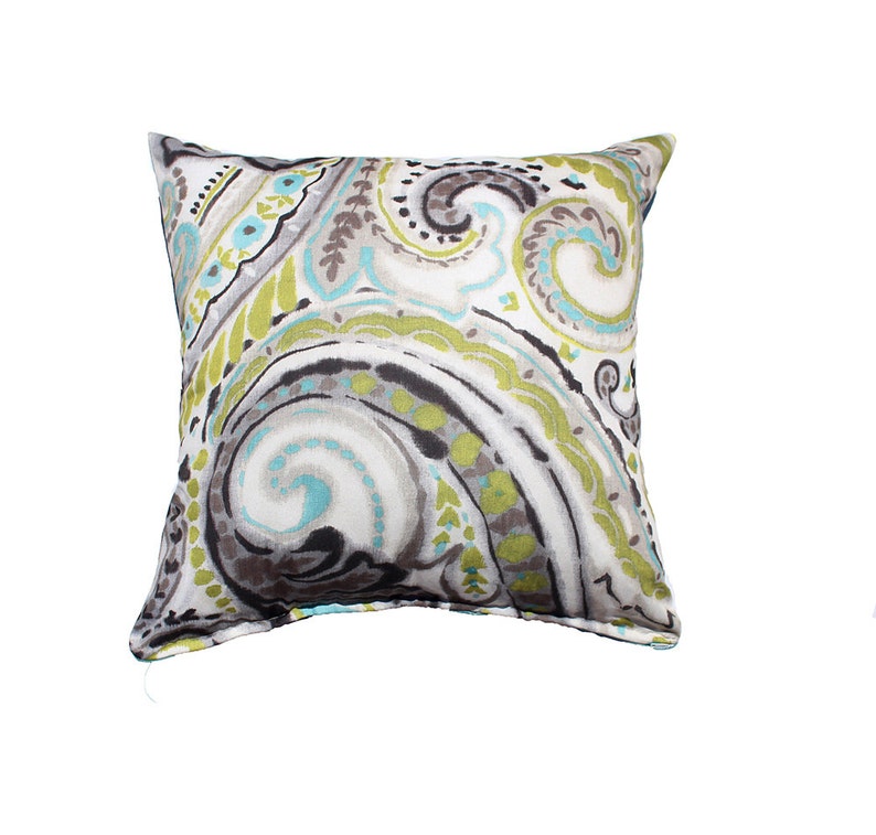 May include: A decorative throw pillow with a paisley pattern in shades of grey, green, and blue.