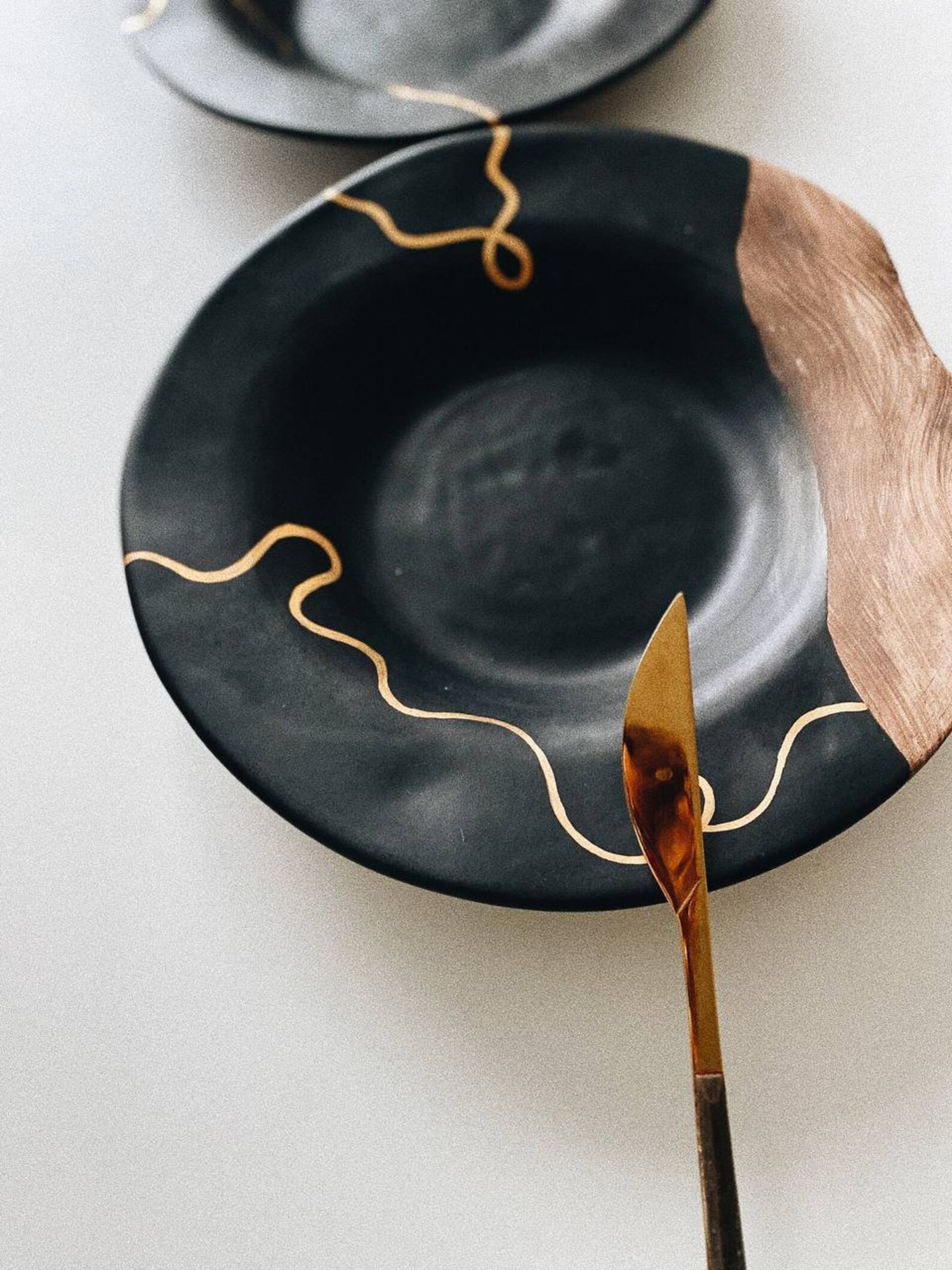 One black plate with golden painting and ceramic unglazed Etsy