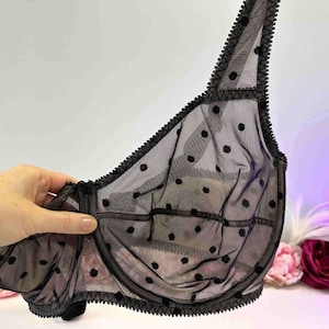 May include: Black polka dot mesh bra with adjustable straps and a delicate lace trim.