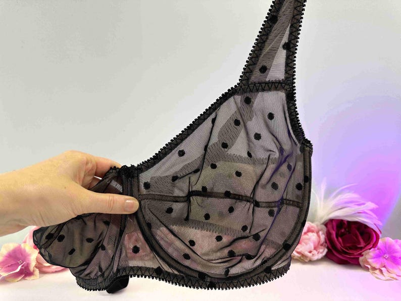 May include: Black polka dot mesh bra with adjustable straps and a delicate lace trim.