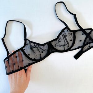 May include: Black polka dot mesh bra with adjustable straps.