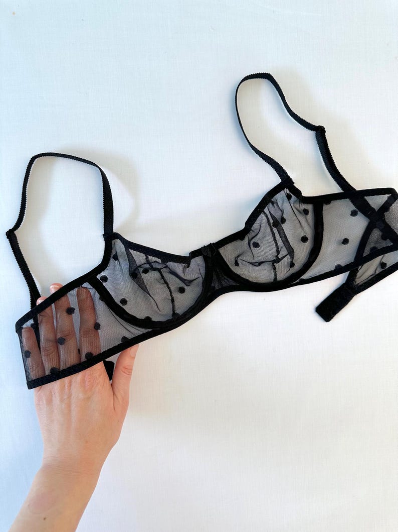 May include: Black polka dot mesh bra with adjustable straps.