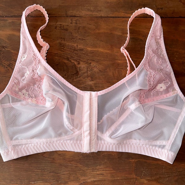 Sheer pink bralette with lace. Front closure.