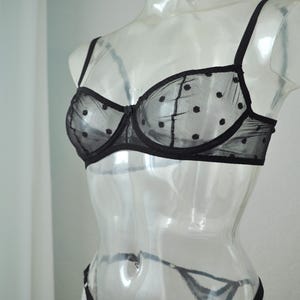 May include: Black polka dot mesh bra with adjustable straps.