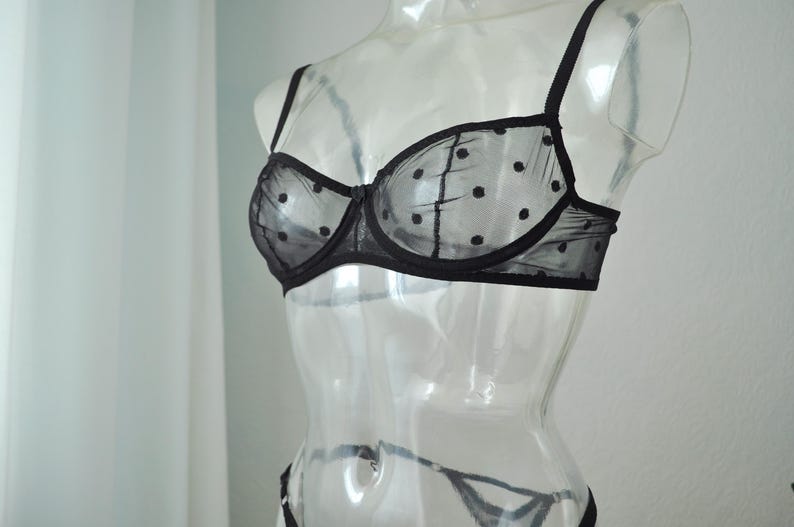 May include: Black polka dot mesh bra with adjustable straps.