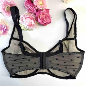 May include: Black polka dot mesh bra with adjustable straps and a hook and eye fastening at the back.