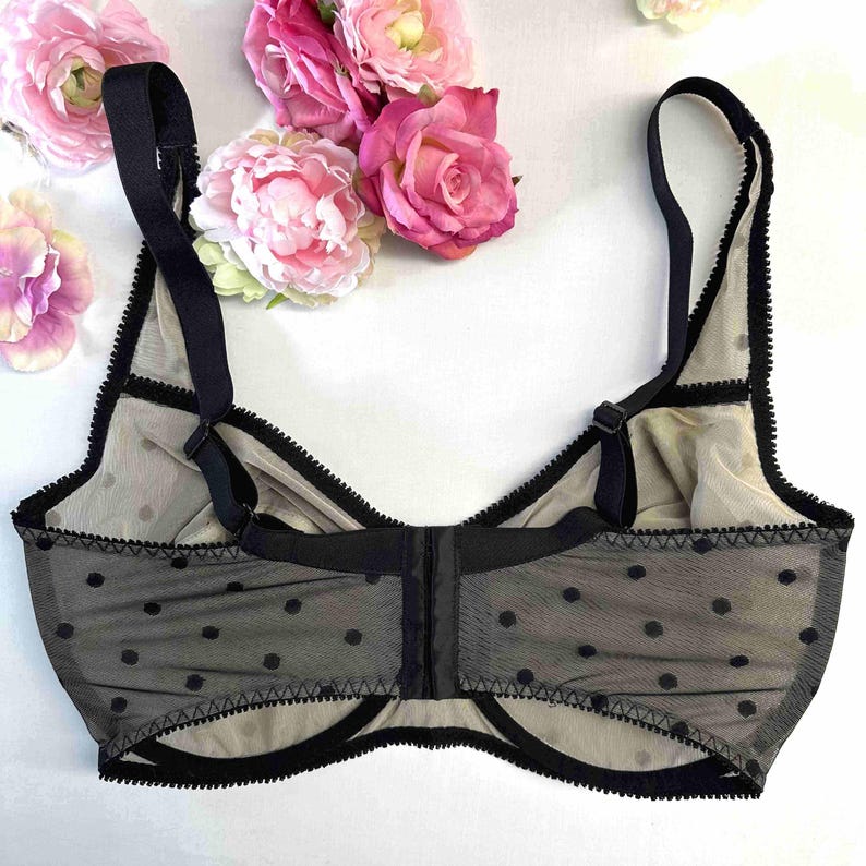 May include: Black polka dot mesh bra with adjustable straps and a hook and eye fastening at the back.
