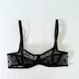 May include: Black polka dot mesh lingerie bra with adjustable straps.